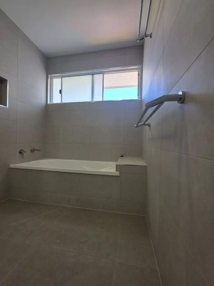Built-in bath and tiled walls in a Brookfield bathroom