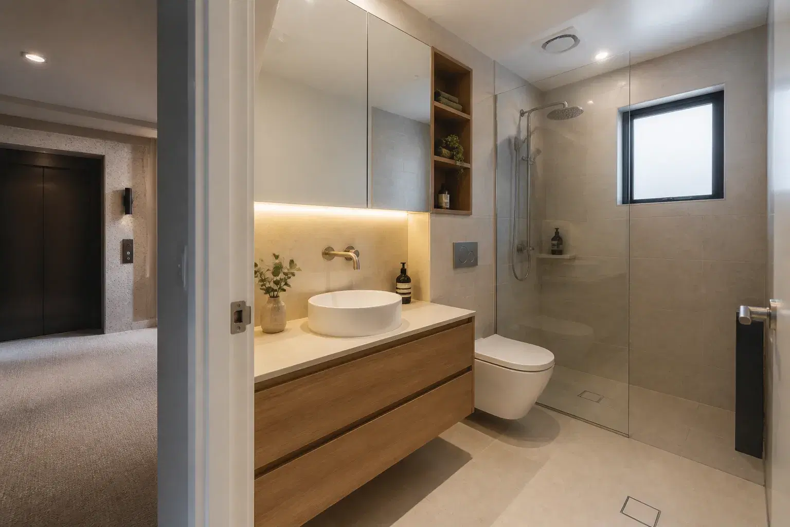 Renovated Brisbane apartment bathroom beside a shared lift lobby