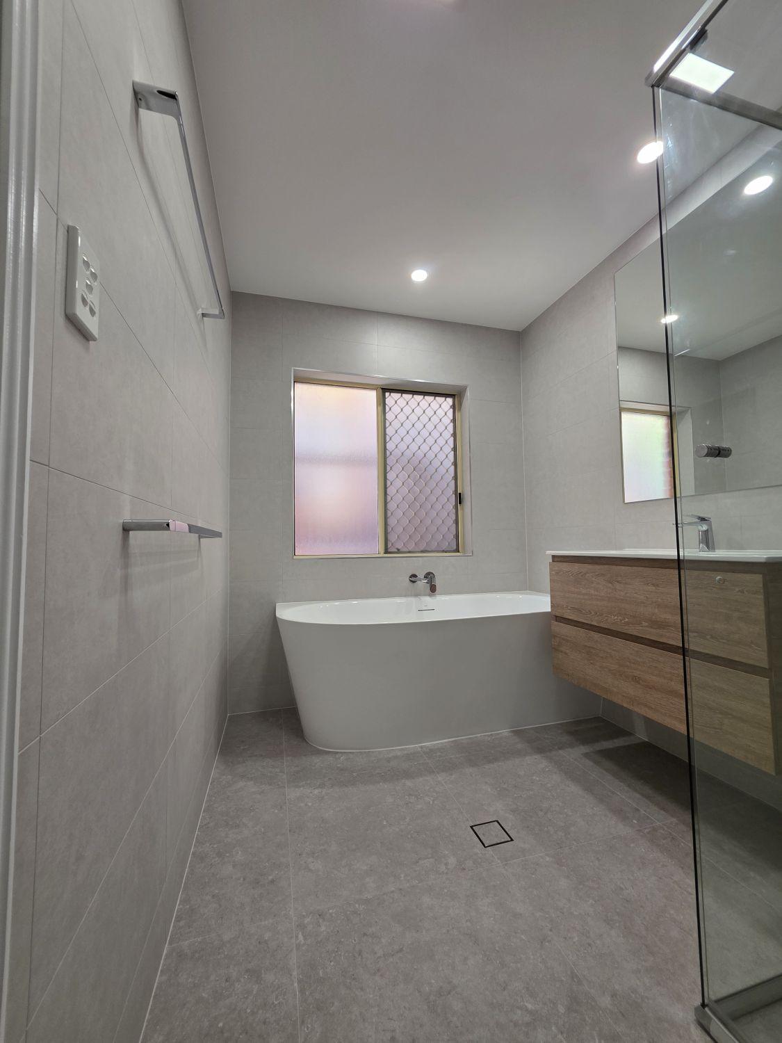 Finished Bellbowrie bathroom viewed toward the freestanding bath and vanity