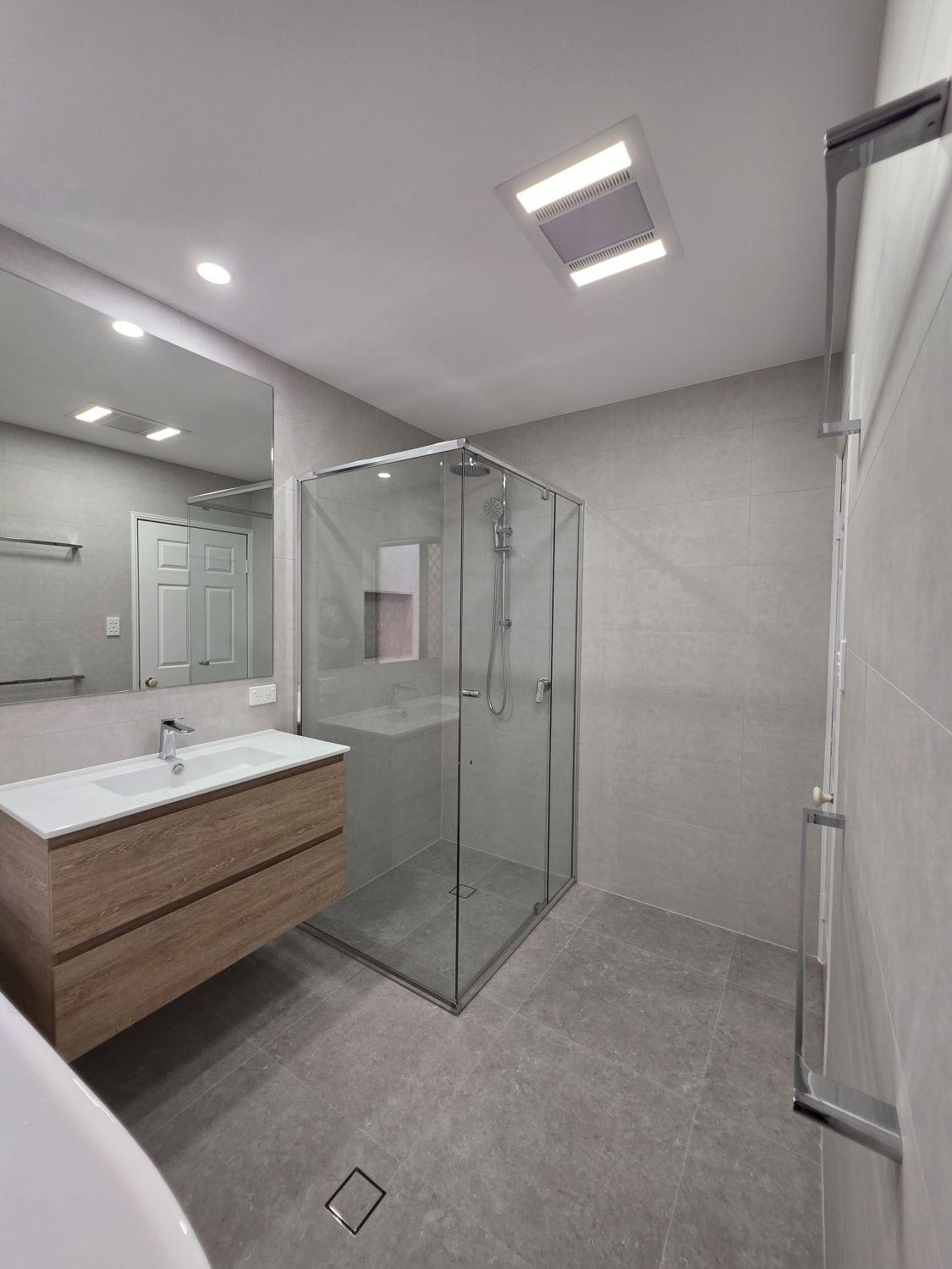 Wide view of the finished Bellbowrie bathroom with shower and floating vanity