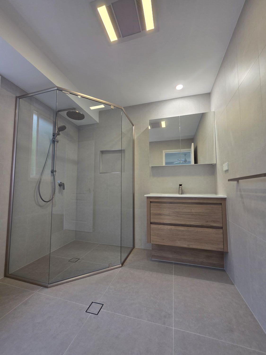 North Lakes ensuite after renovation with larger glass shower and timber-look vanity