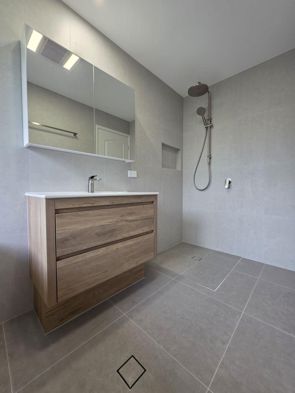 Open shower and timber-look vanity in the renovated North Lakes main bathroom