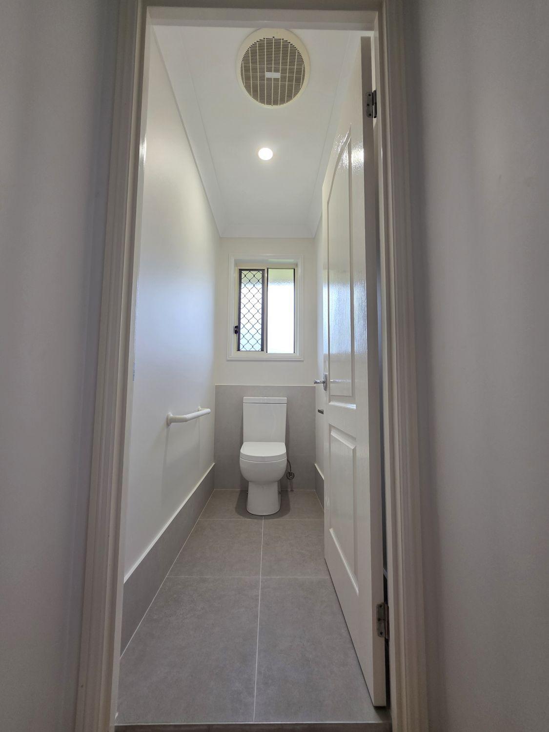 North Lakes separate toilet after renovation with grey tile and white walls