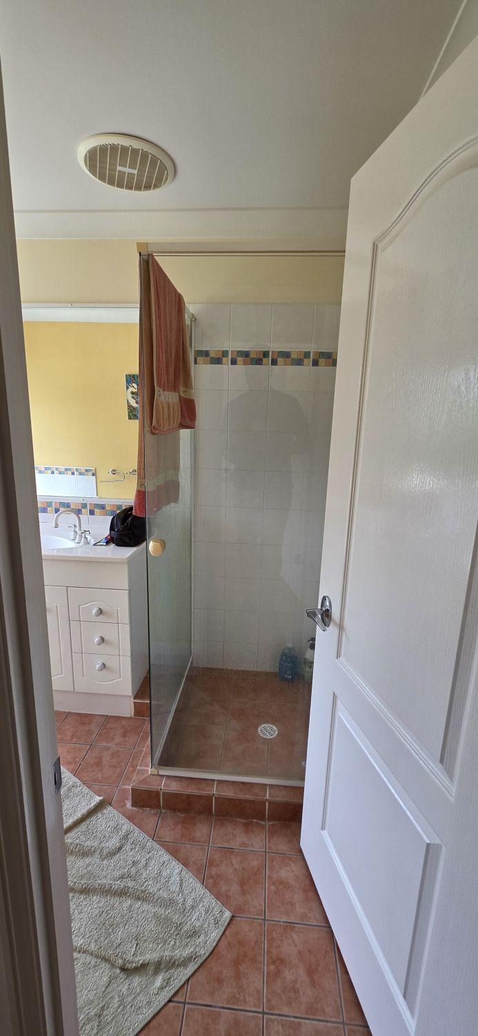 North Lakes main bathroom before renovation with raised framed shower