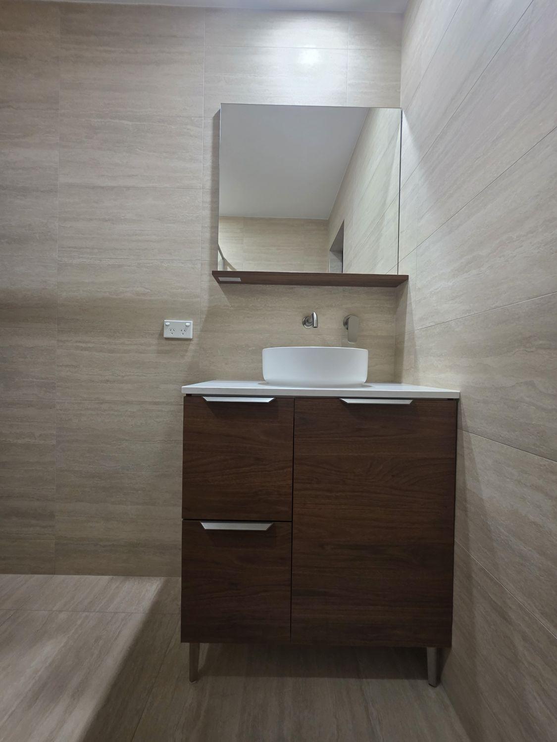 Compact timber-look vanity with vessel basin in the Wishart downstairs bathroom
