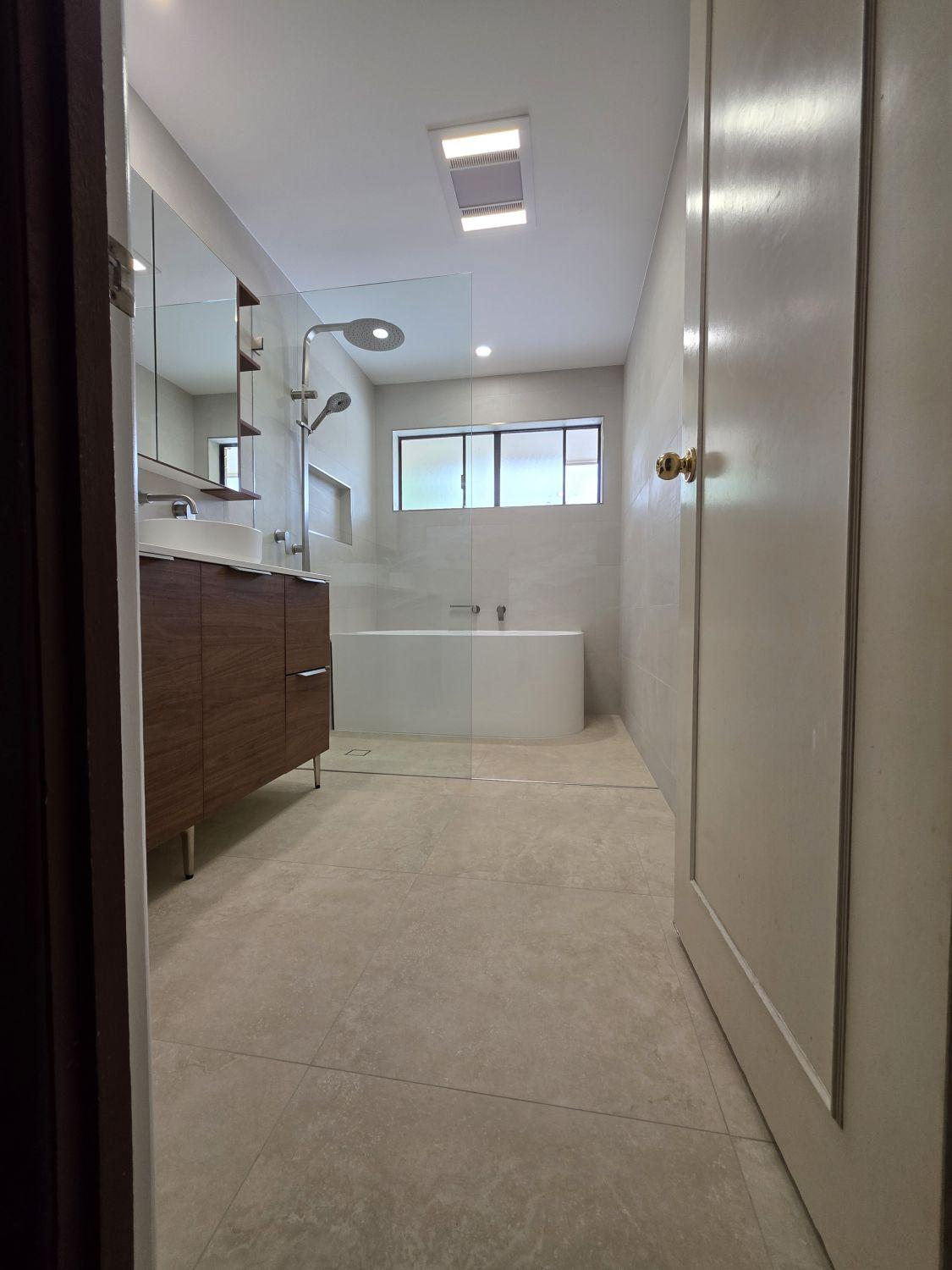 Completed Wishart main bathroom with freestanding bath, glass shower and double vanity