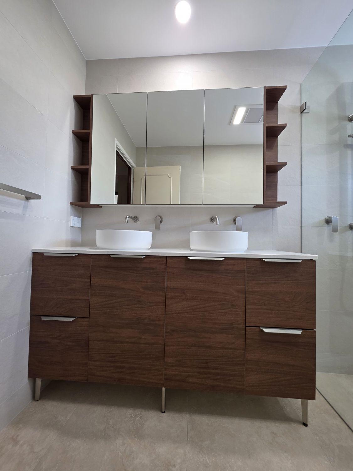 Double timber-look vanity and mirrored storage in the Wishart main bathroom