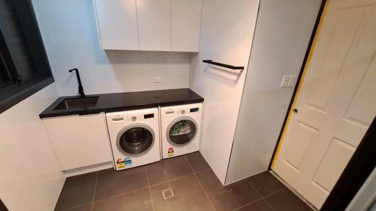 Completed white and black laundry renovation in Brisbane