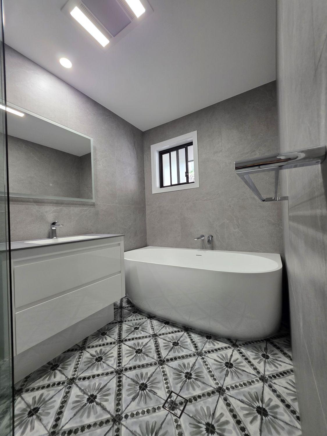 Renovated Augustine Heights bathroom with freestanding bath and floating white vanity
