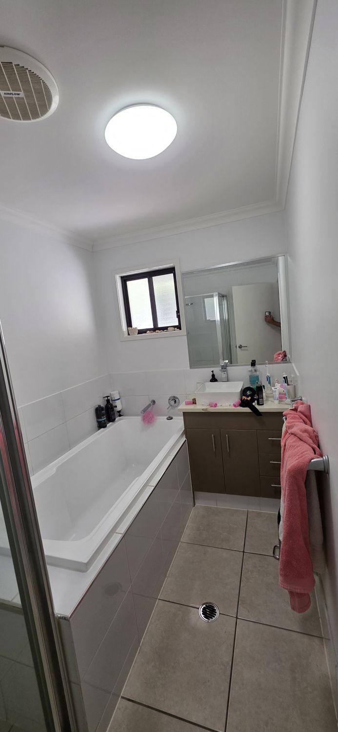 Original Augustine Heights bathroom with built-in bath and floor-standing vanity