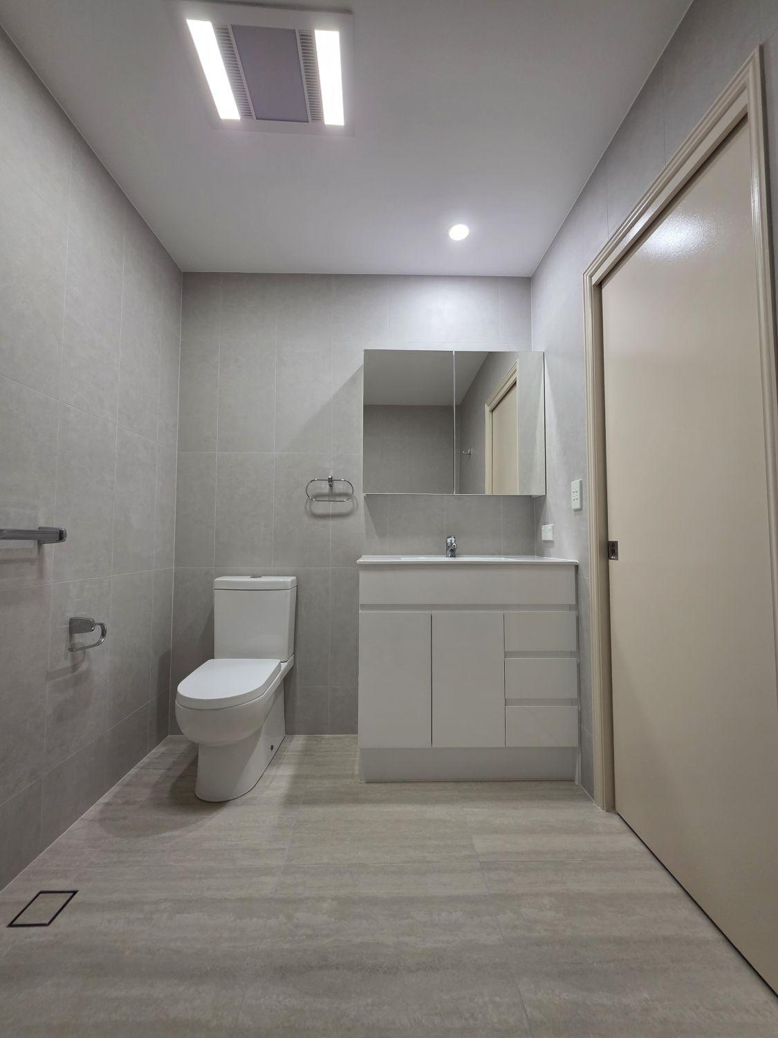 Bardon bathroom toilet and wide white vanity after renovation