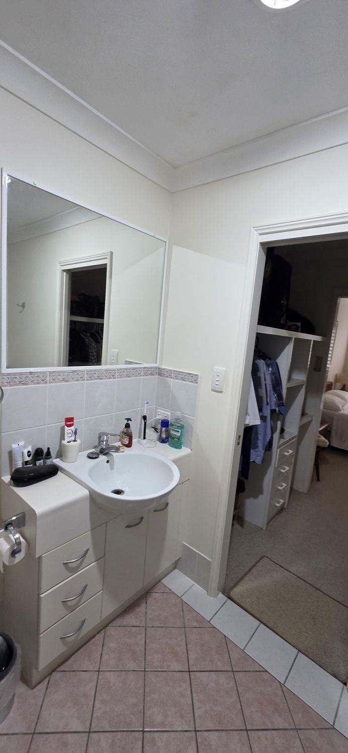 Original compact vanity and mirror in the Bardon bathroom