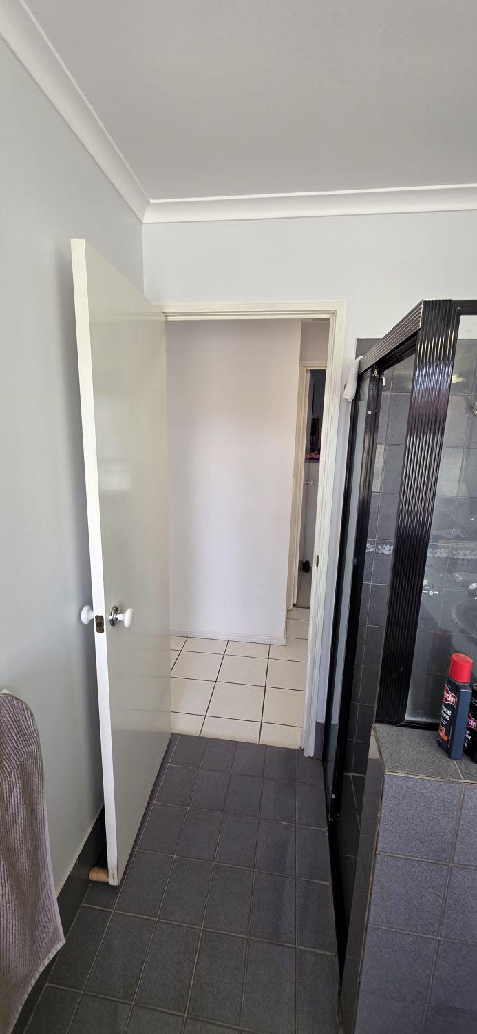 Calamvale bathroom before renovation looking toward the doorway and framed shower