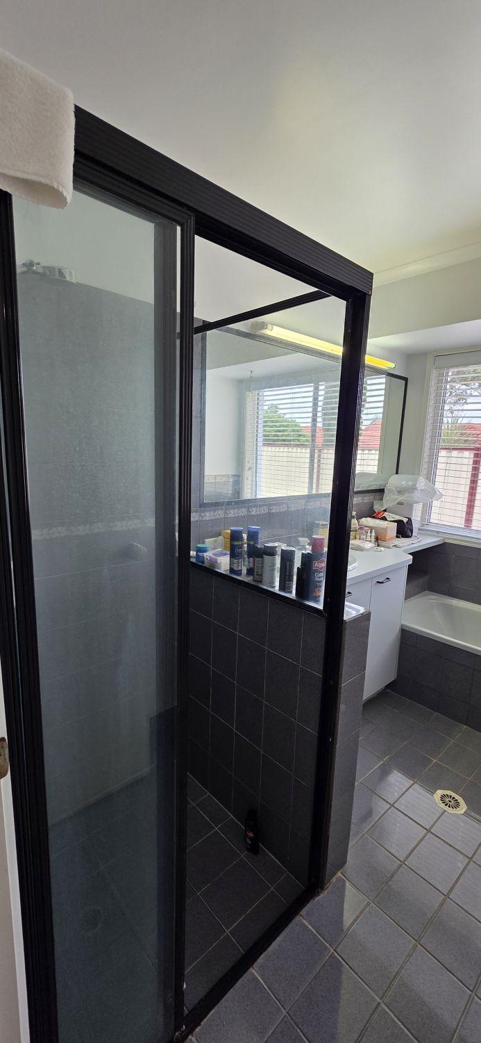 Original black-framed shower in the Calamvale bathroom