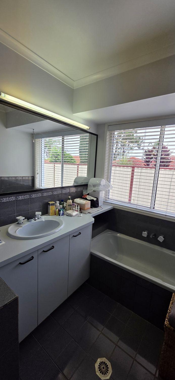Original Calamvale bathroom with single vanity beside the built-in bath
