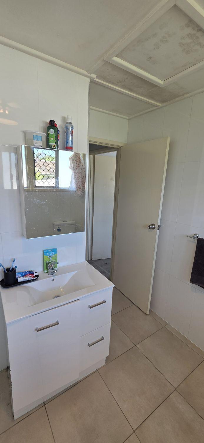 Original floor-standing vanity and mirror in the Inala bathroom