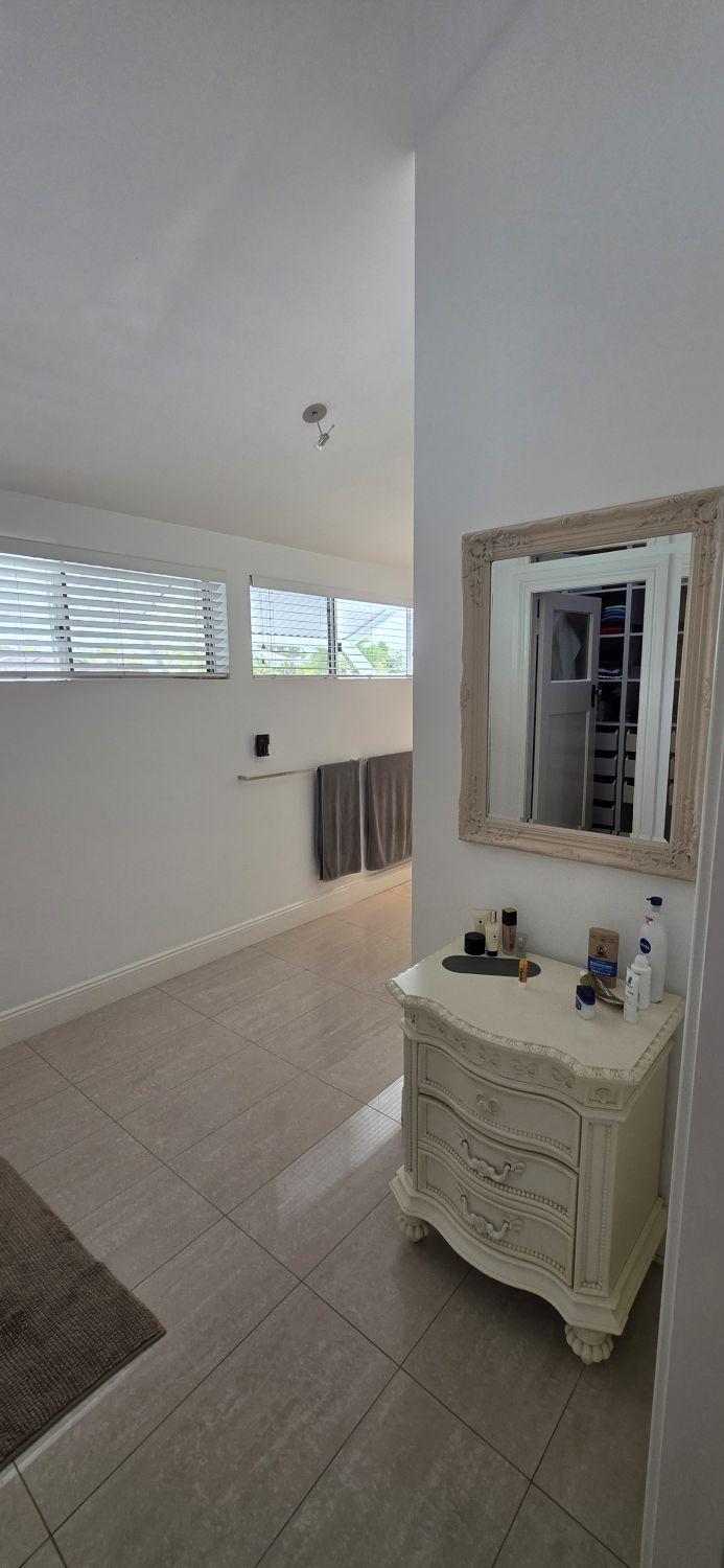 Kalinga ensuite before renovation with furniture-style vanity and open dressing area