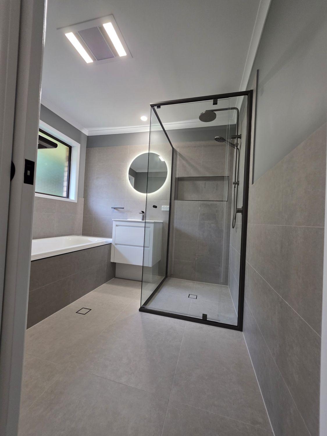 Second Karana Downs bathroom after renovation with glass shower, bath and floating vanity