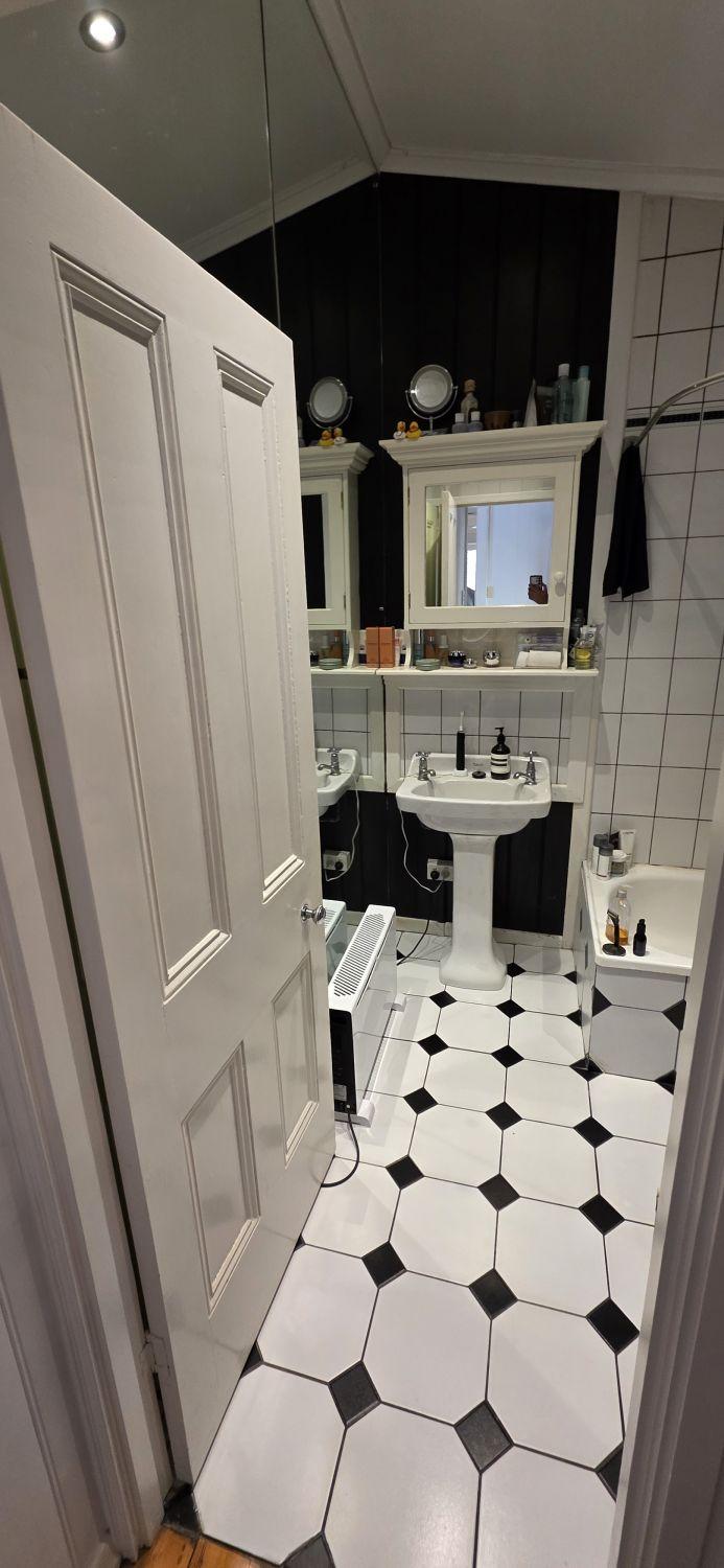 Stones Corner bathroom before renovation with pedestal basin and patterned floor