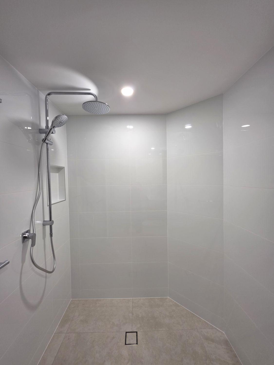Open level-entry shower in the completed Taringa bathroom