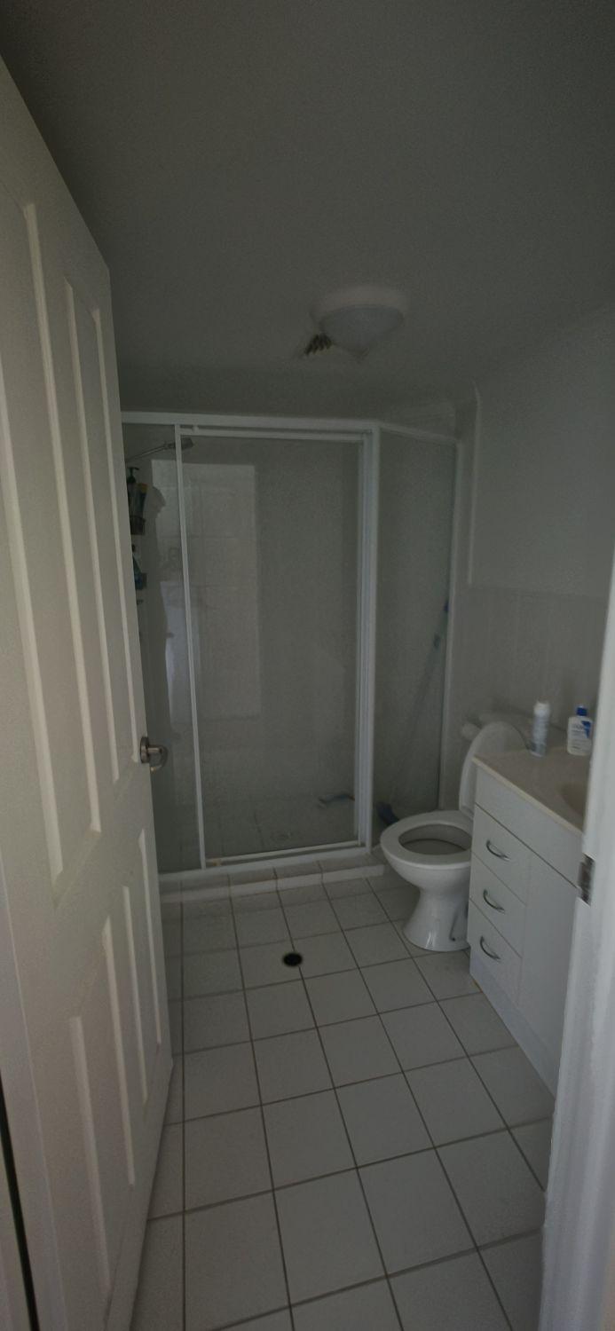 Taringa bathroom entrance before renovation with raised framed shower