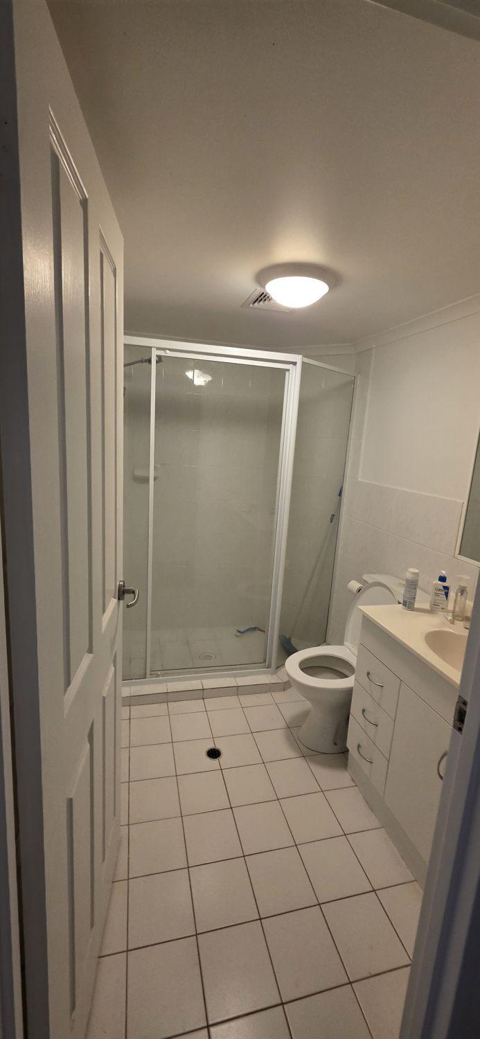 Raised enclosed shower in the Taringa bathroom before renovation