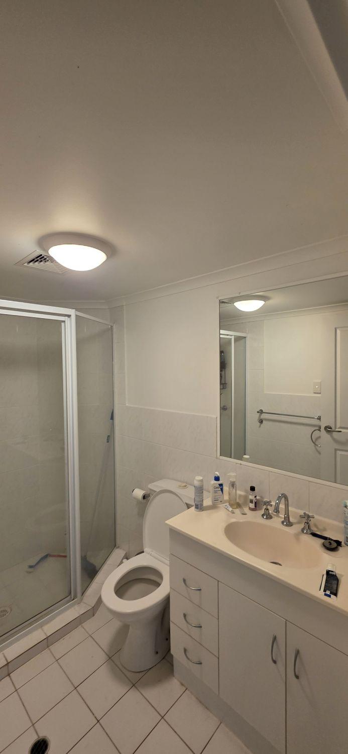 Original Taringa bathroom with framed shower, toilet and vanity