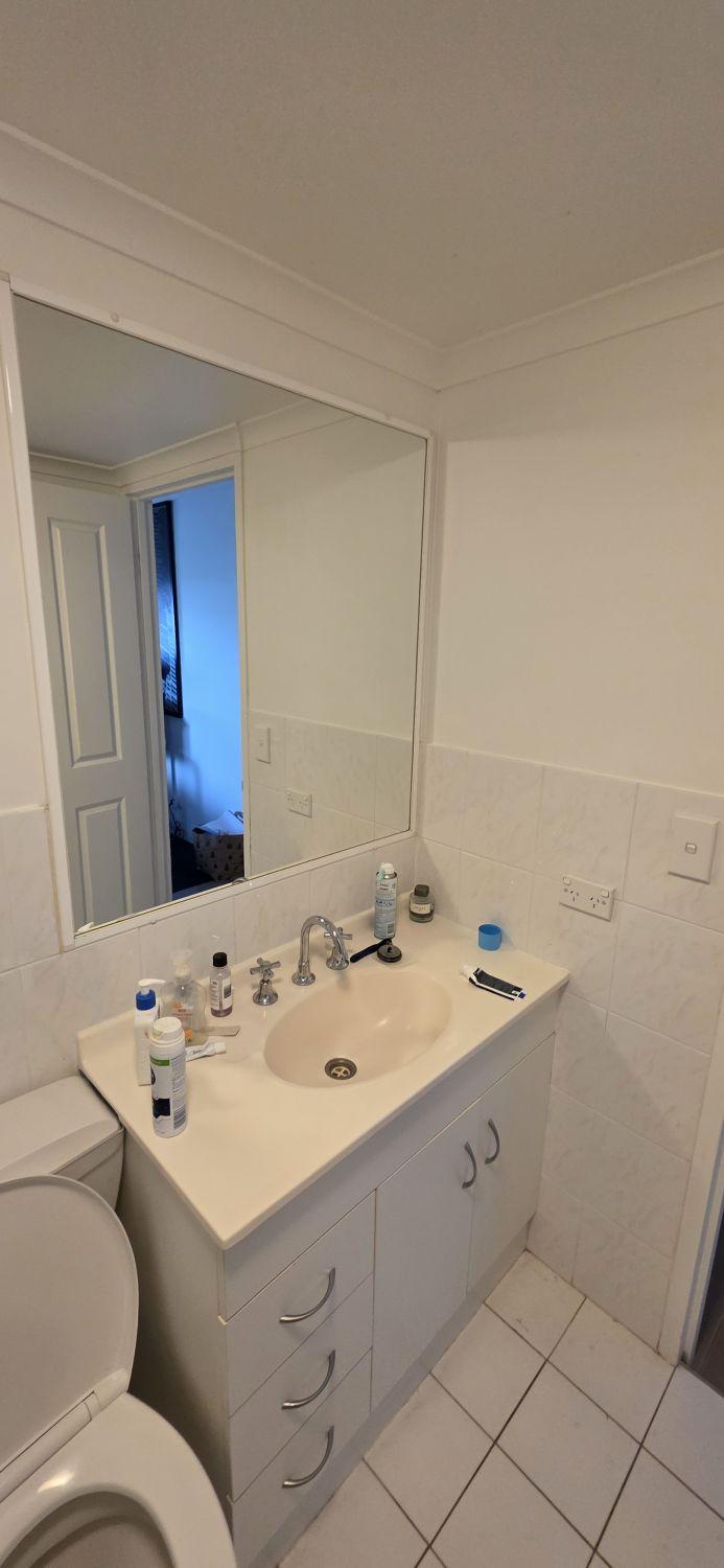 Original white vanity and mirror in the Taringa bathroom