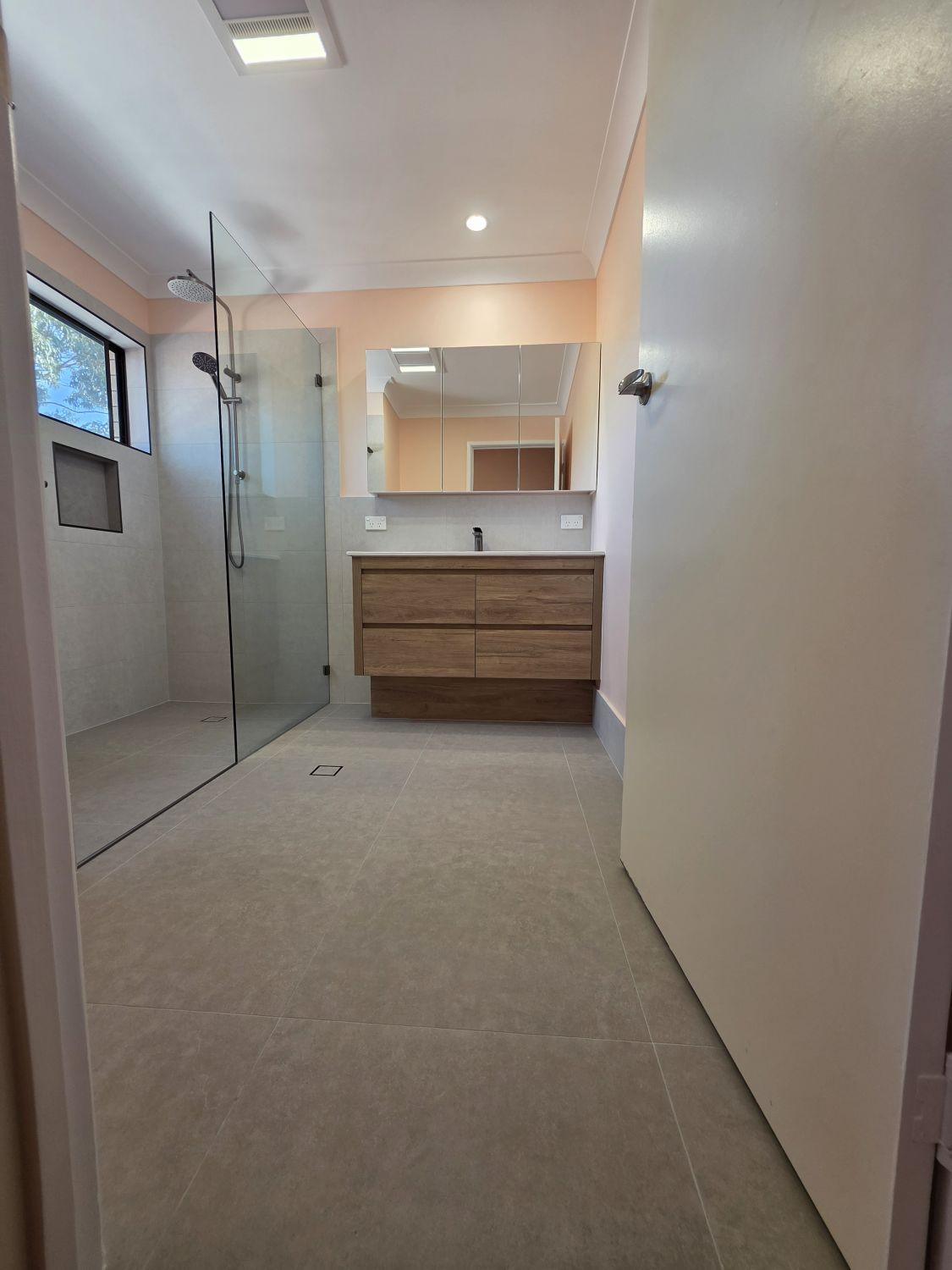 Tarragindi bathroom entrance after renovation with open shower and wide vanity