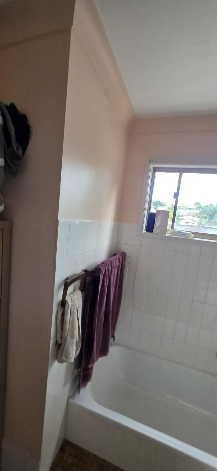 Built-in bath below the window in the Tarragindi bathroom before renovation