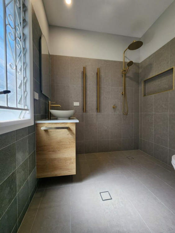 Beautifully renovated bathroom in Brisbane’s Bardon suburb featuring modern fixtures, sleek tiling, and a spacious layout.