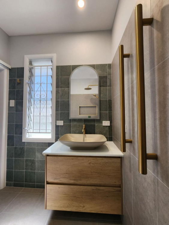 Beautifully renovated bathroom in Brisbane’s Bardon suburb featuring modern fixtures, sleek tiling, and a spacious layout.