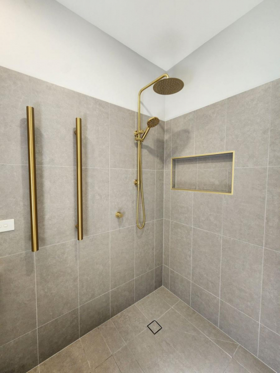 Beautifully renovated bathroom in Brisbane’s Bardon suburb featuring modern fixtures, sleek tiling, and a spacious layout.