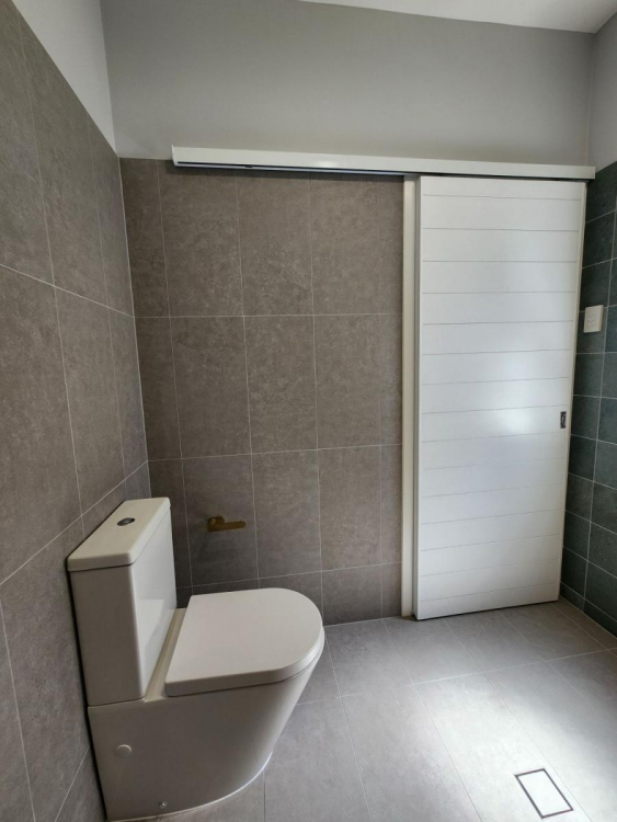 Beautifully renovated bathroom in Brisbane’s Bardon suburb featuring modern fixtures, sleek tiling, and a spacious layout.