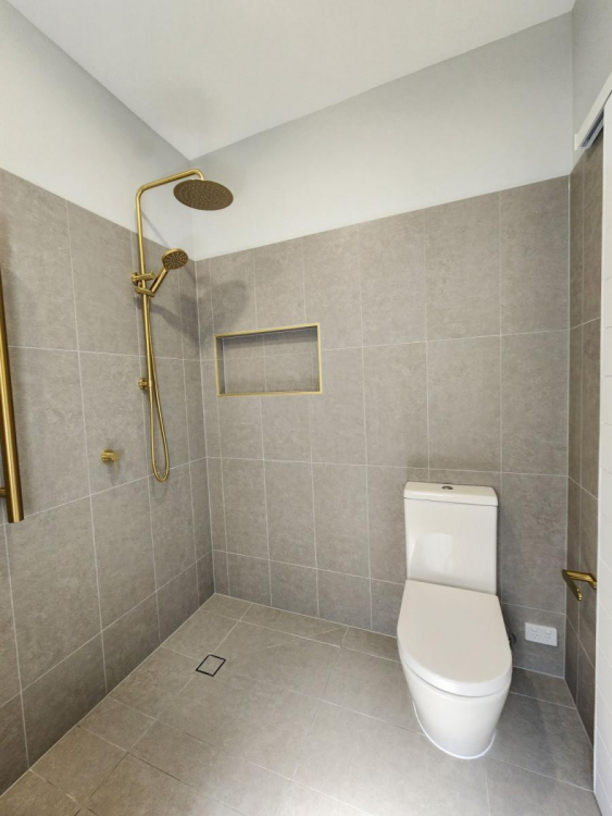 Beautifully renovated bathroom in Brisbane’s Bardon suburb featuring modern fixtures, sleek tiling, and a spacious layout.